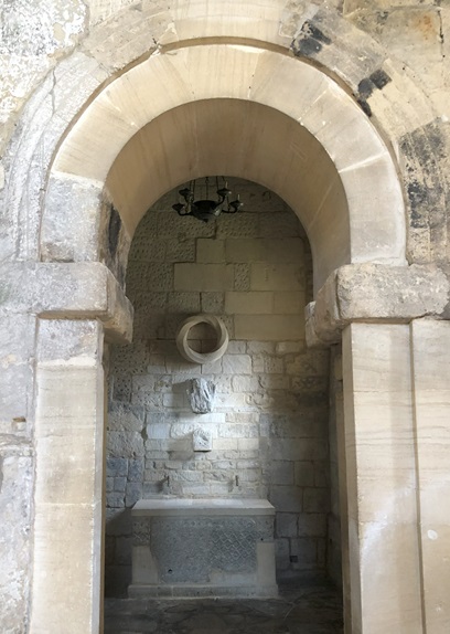 A doorway in a chuch with an altar.